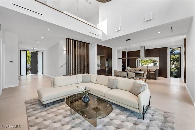 living room with baseboards and recessed lighting