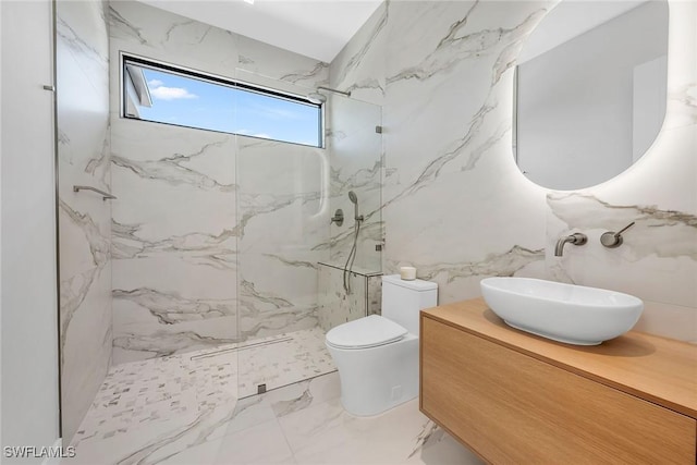 bathroom with tile walls, a marble finish shower, marble finish floor, and toilet