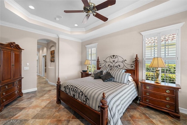 bedroom with a tray ceiling, ceiling fan, and crown molding