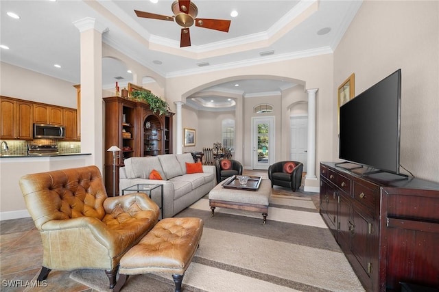 living room with ceiling fan, crown molding, and decorative columns