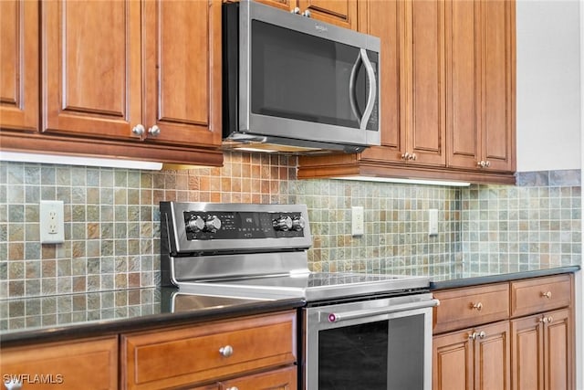 kitchen with backsplash and appliances with stainless steel finishes