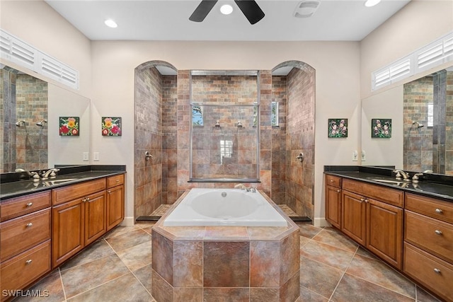 bathroom with tile patterned floors, vanity, ceiling fan, and plus walk in shower