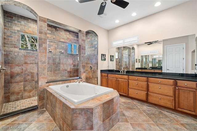 bathroom featuring vanity, ceiling fan, and independent shower and bath