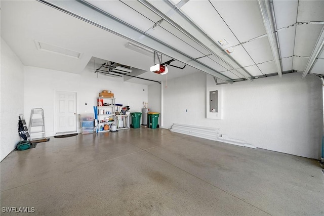 garage featuring electric panel and a garage door opener