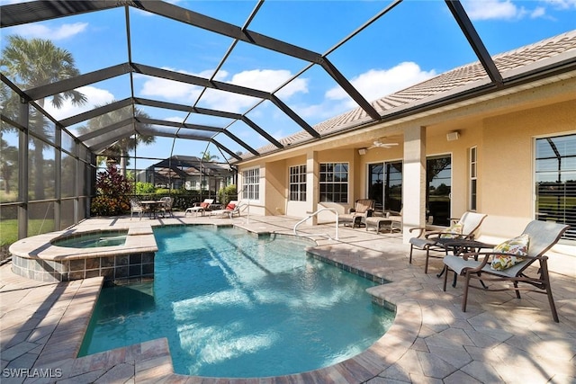 view of pool with an in ground hot tub, a patio, ceiling fan, and a lanai