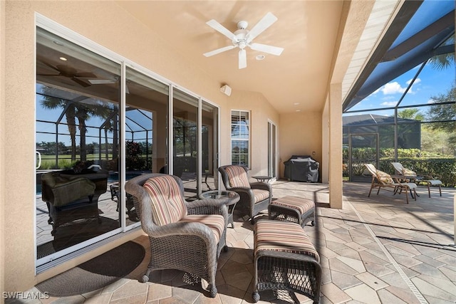 view of patio with grilling area, ceiling fan, and a lanai