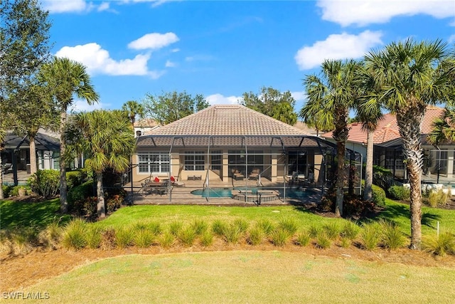 back of house with a yard, a patio, glass enclosure, and a pool with hot tub