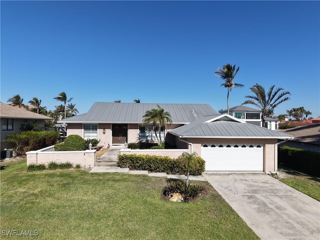 view of front of property featuring a garage and a front lawn