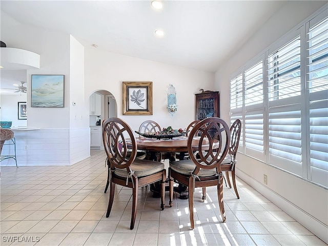 dining space featuring light tile patterned floors and lofted ceiling