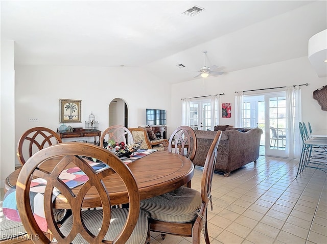 dining room featuring ceiling fan, vaulted ceiling, light tile patterned floors, and french doors