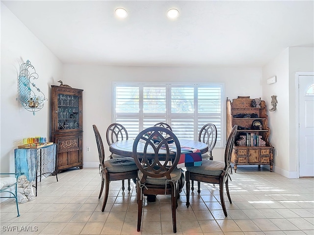 dining space featuring light tile patterned floors