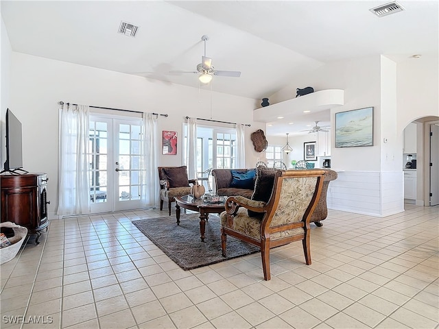 living room with french doors, vaulted ceiling, light tile patterned floors, and ceiling fan