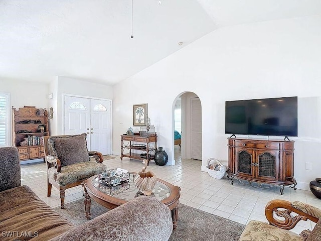 tiled living room with a wealth of natural light and vaulted ceiling