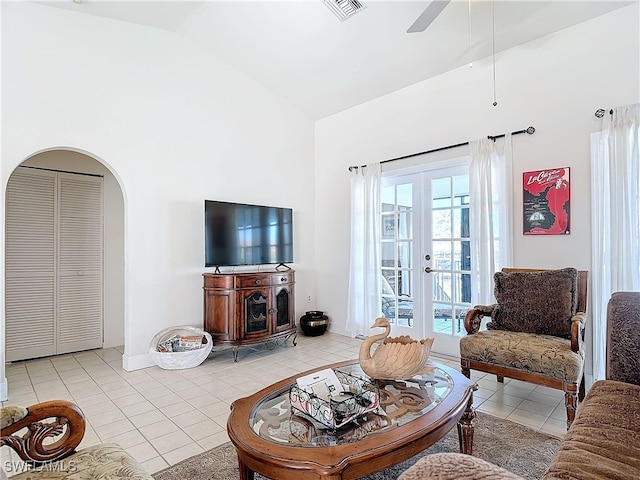 living room featuring ceiling fan, light tile patterned floors, high vaulted ceiling, and french doors