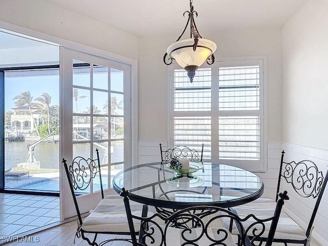 dining area featuring a water view and hardwood / wood-style flooring