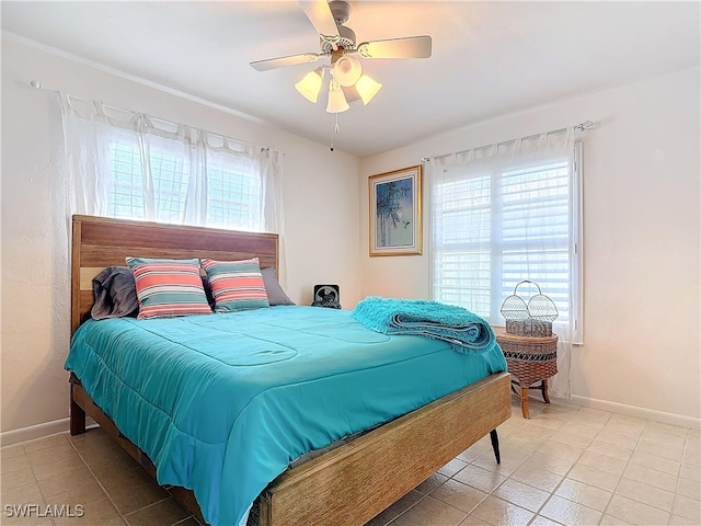 bedroom with ceiling fan and light tile patterned flooring