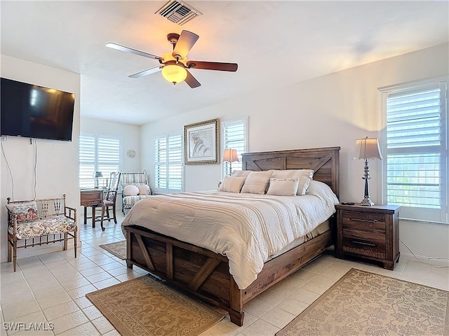 tiled bedroom featuring ceiling fan