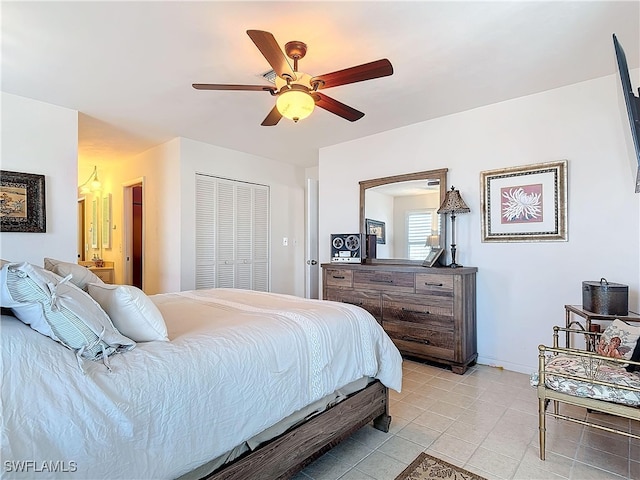 tiled bedroom featuring a closet and ceiling fan