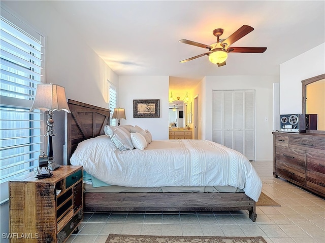 bedroom with light tile patterned floors, a closet, and ceiling fan