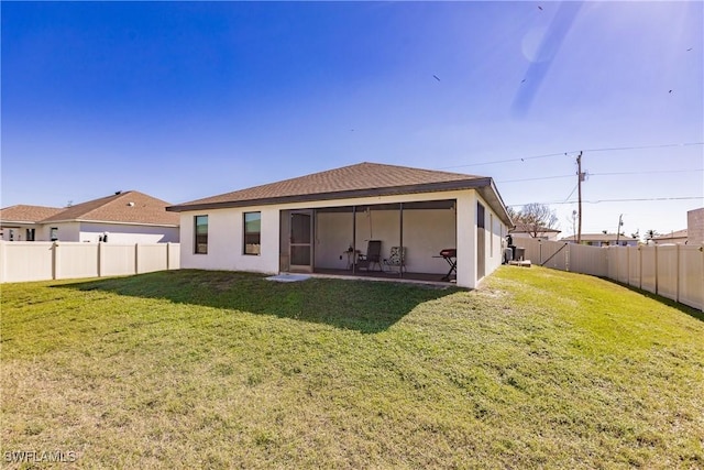 rear view of property with a yard