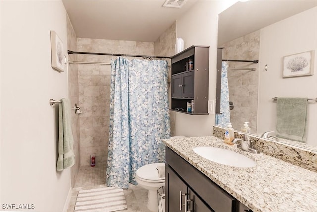 bathroom featuring vanity, toilet, and walk in shower