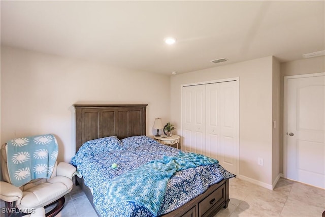 bedroom featuring a closet and light tile patterned flooring