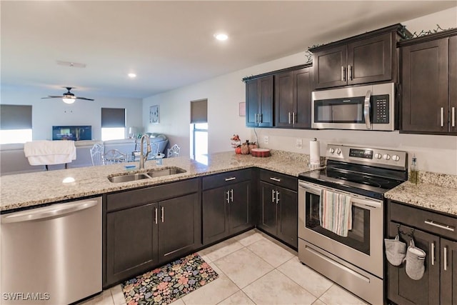 kitchen featuring sink, ceiling fan, appliances with stainless steel finishes, dark brown cabinets, and kitchen peninsula