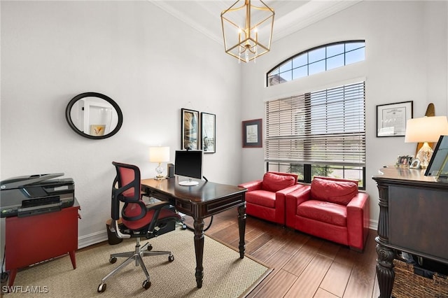 office featuring crown molding, plenty of natural light, hardwood / wood-style floors, and an inviting chandelier