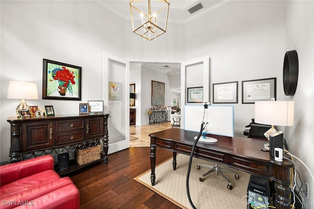 home office with ornamental molding, a towering ceiling, an inviting chandelier, and dark wood-type flooring