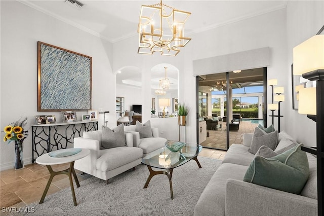 living room with a high ceiling, an inviting chandelier, and crown molding