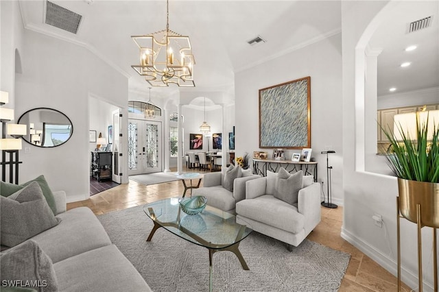 living room featuring vaulted ceiling, ornamental molding, and a notable chandelier