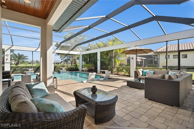 view of patio / terrace featuring outdoor lounge area and glass enclosure