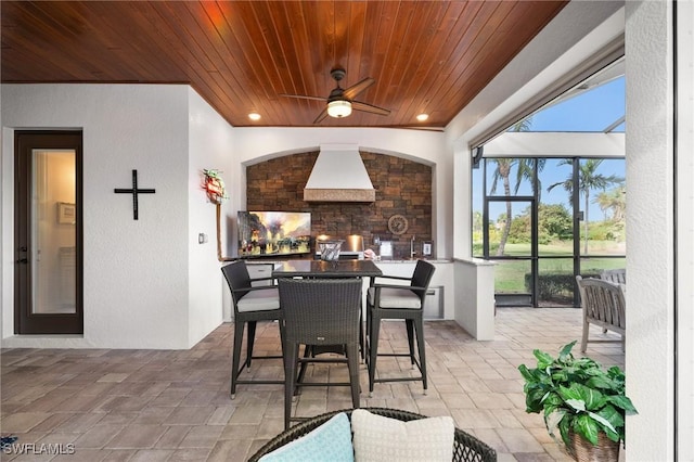 dining area with a wealth of natural light, ceiling fan, and wood ceiling