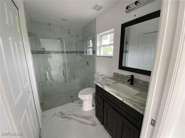 bathroom with vanity, toilet, and an enclosed shower