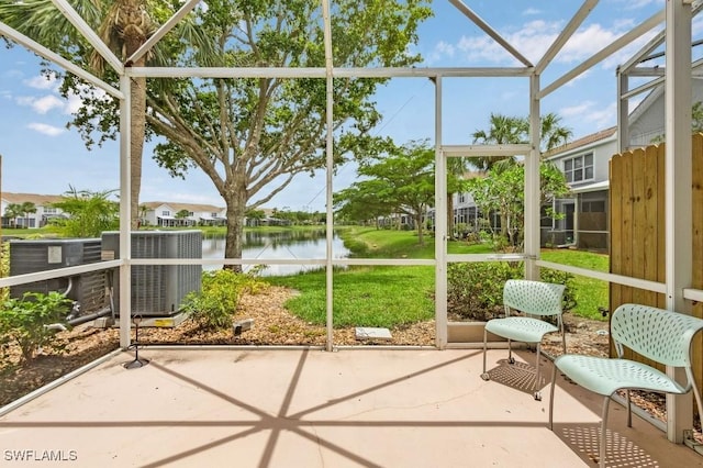 unfurnished sunroom featuring a water view