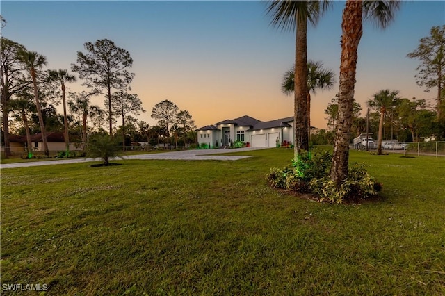 yard at dusk with a garage