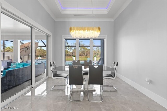 dining room with ornamental molding and an inviting chandelier