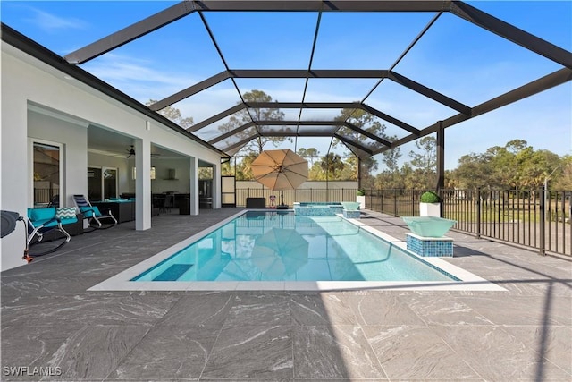 view of swimming pool with a patio area, an in ground hot tub, ceiling fan, and glass enclosure