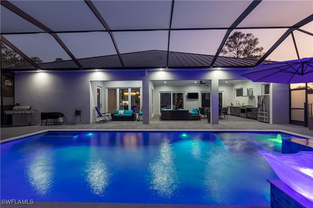 view of swimming pool with outdoor lounge area, ceiling fan, a patio area, and glass enclosure