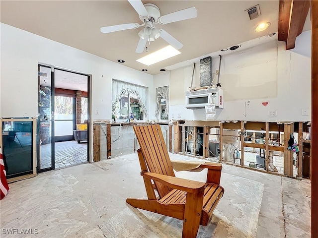 interior space with white cabinetry and ceiling fan