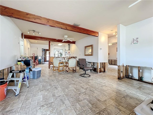 living room featuring ceiling fan and beamed ceiling