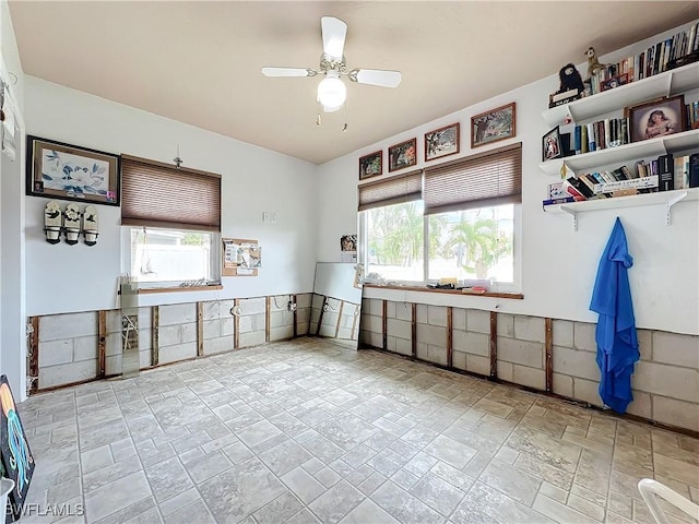 interior space with ceiling fan