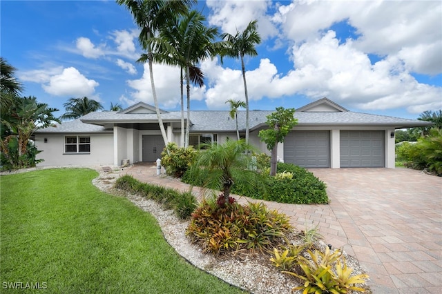 view of front of house featuring a front yard and a garage