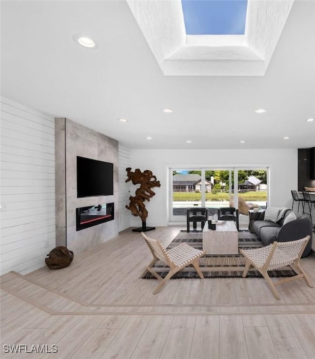 living room featuring light hardwood / wood-style floors and a fireplace