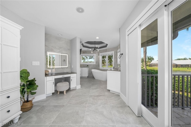 bathroom featuring a washtub and vanity