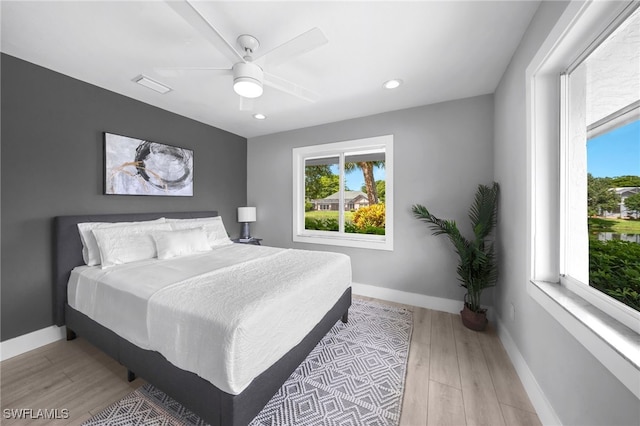 bedroom featuring light hardwood / wood-style floors and ceiling fan