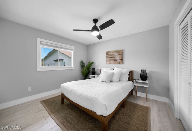 bedroom featuring light hardwood / wood-style flooring, a closet, and ceiling fan