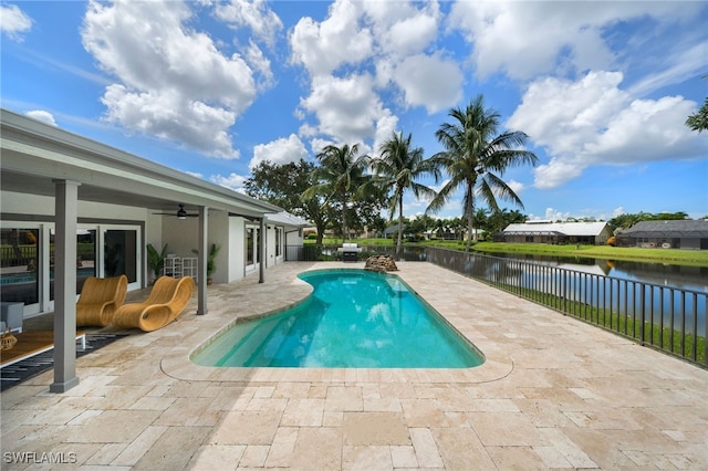 view of pool featuring a patio, a water view, and ceiling fan