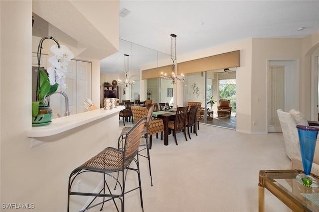 carpeted dining room featuring ceiling fan with notable chandelier