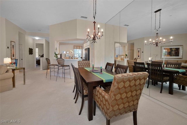 dining room with light carpet and a notable chandelier